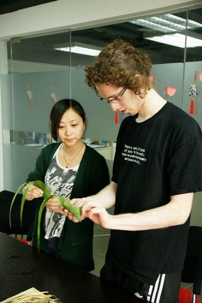A student from Austria learning how to wrap a Zongzi